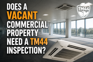 Vacant commercial office with air conditioning units and title asking if a vacant commercial property needs a TM44 inspection.